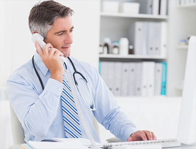 Male doctor using telephone